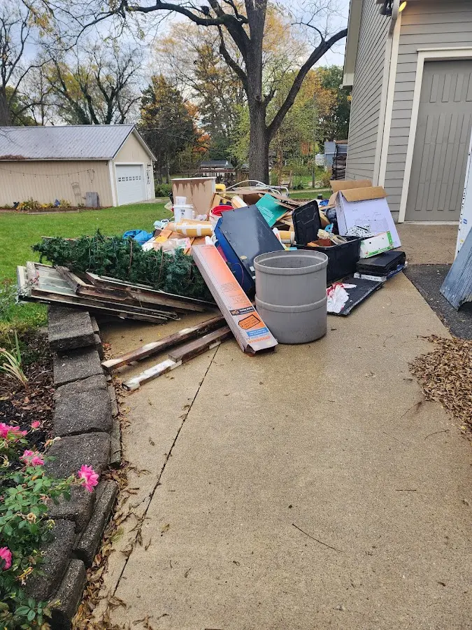 Dumpster being loaded with debris for Estate Cleanout Dumpster Rental in Hope